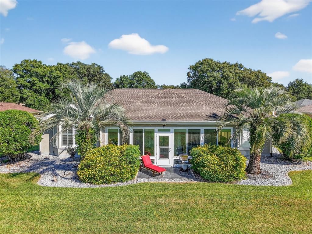 13536 Southeast 97th Terrace Road Summerfield, FL 34491 - Photo 28 of 34 a front view of a house with a yard and potted plants