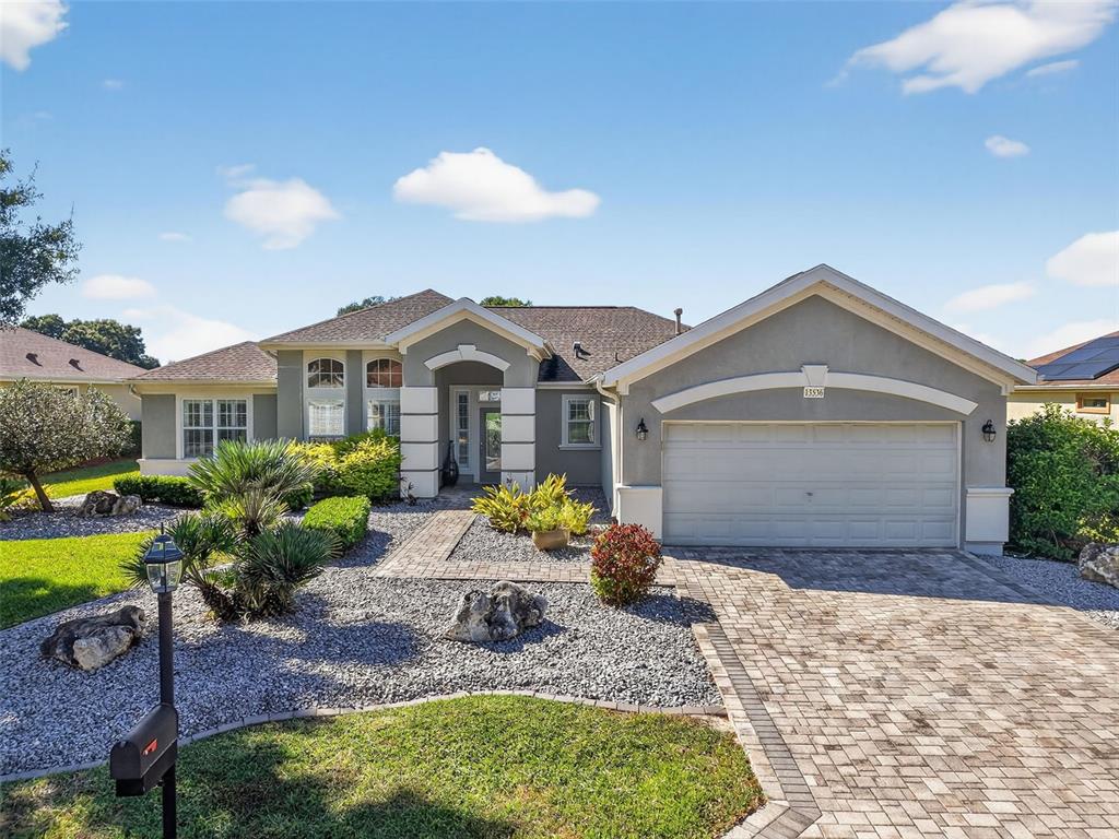 13536 Southeast 97th Terrace Road Summerfield, FL 34491 - Photo 3 of 34 a front view of a house with garden