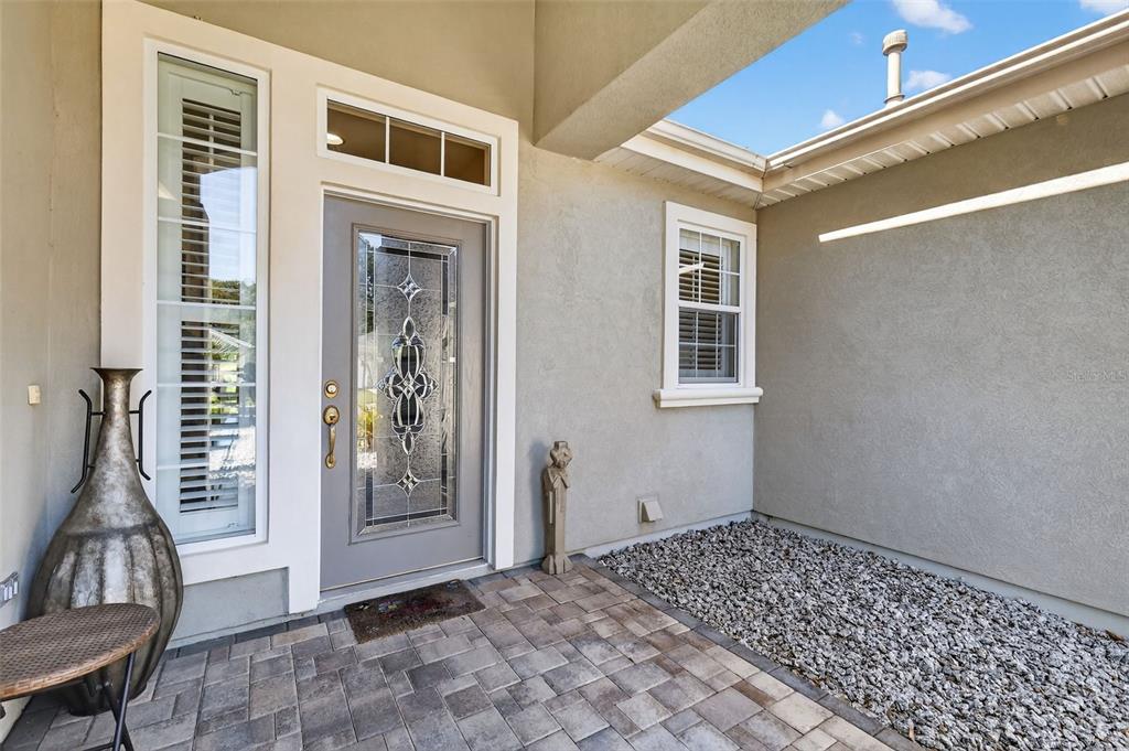 13536 Southeast 97th Terrace Road Summerfield, FL 34491 - Photo 4 of 34 a view of an entryway with wooden floor and door