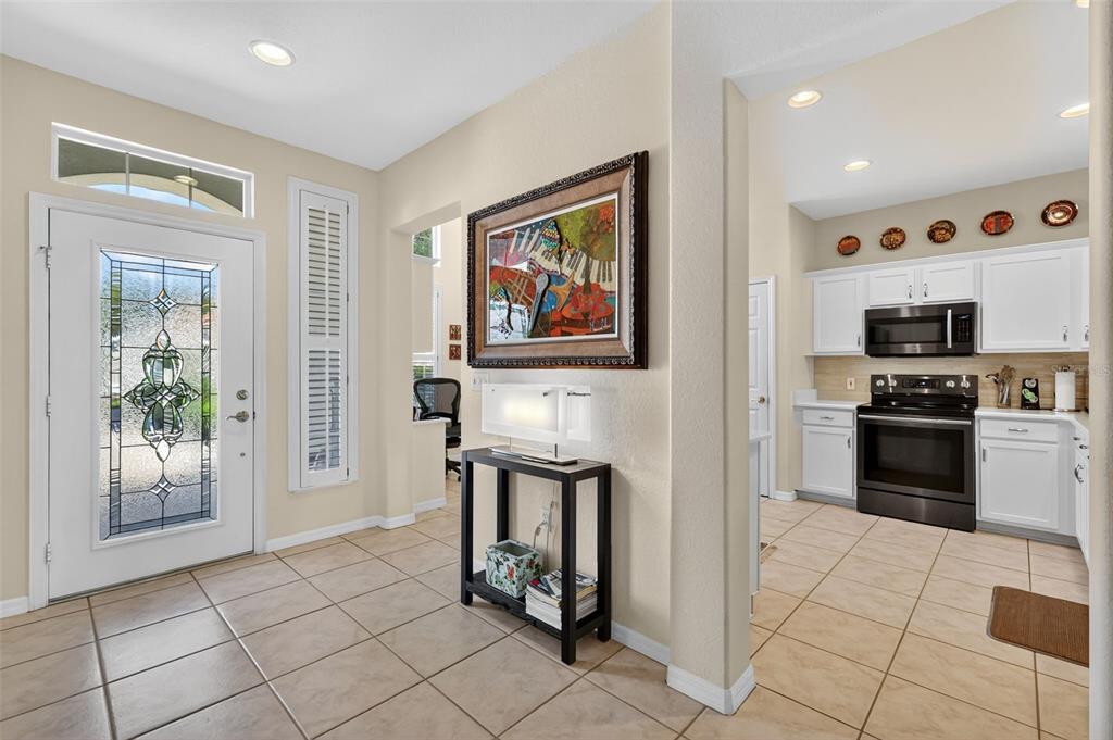 13536 Southeast 97th Terrace Road Summerfield, FL 34491 - Photo 5 of 34 a kitchen with stainless steel appliances granite countertop a refrigerator and a stove top oven