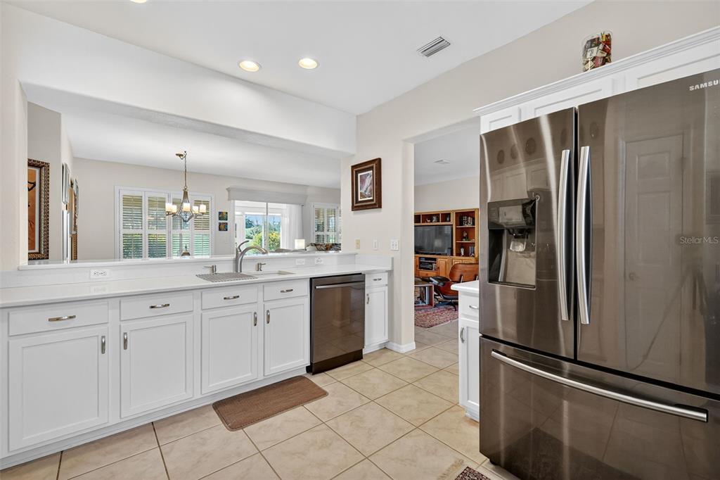13536 Southeast 97th Terrace Road Summerfield, FL 34491 - Photo 8 of 34 a kitchen with white cabinets and stainless steel appliances