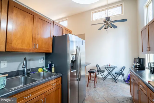 a kitchen with stainless steel appliances granite countertop a sink counter space and a table