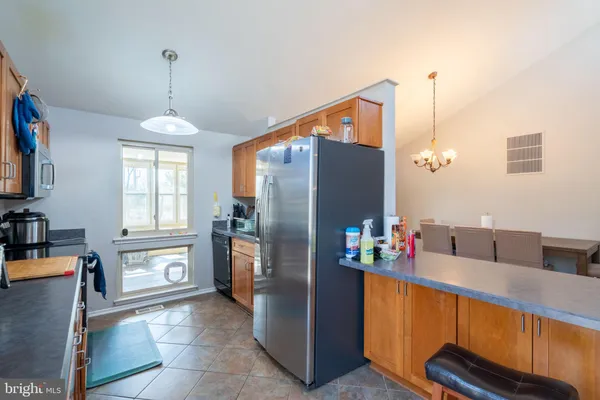 a kitchen with stainless steel appliances granite countertop a stove a sink dishwasher and a microwave oven with cabinets