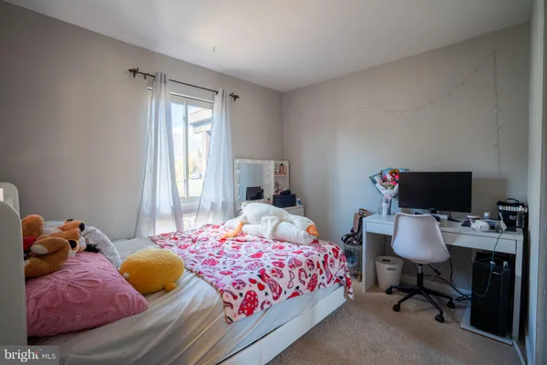 a bedroom with a bed and a mirror