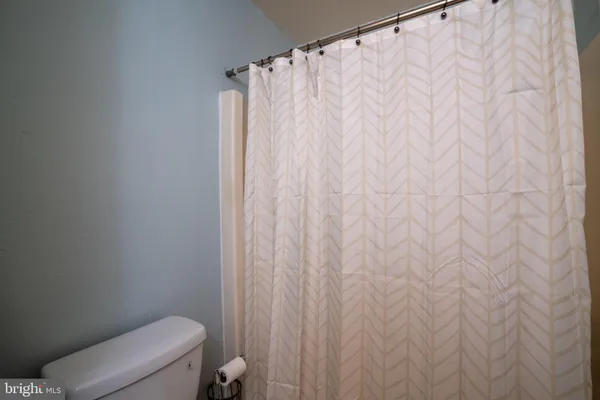 a bedroom with a bed and a ceiling fan