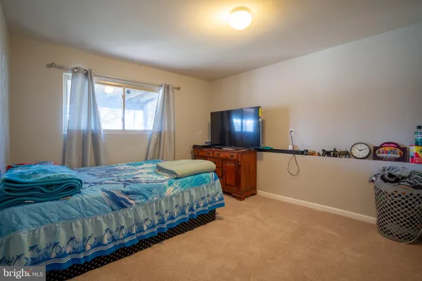 a bedroom with bed and furniture