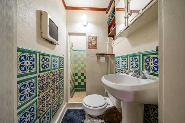 a bathroom with a sink a toilet and a mirror