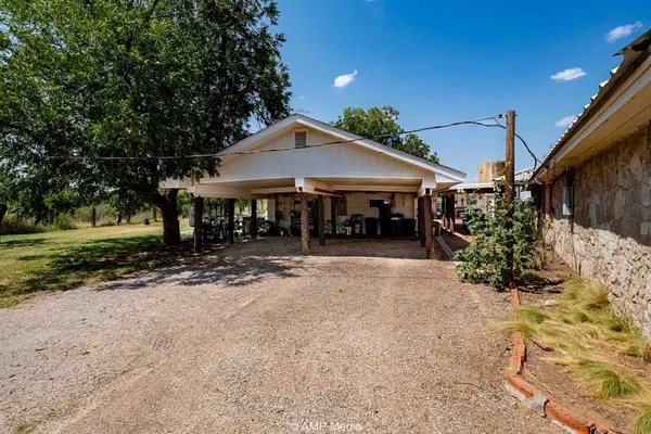 a view of a house with a yard and tree s