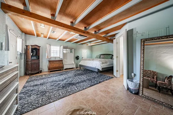 a spacious bedroom with a bed and glass door