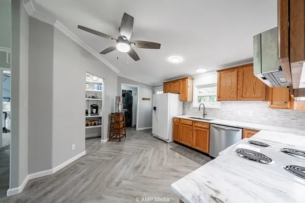 a view of a kitchen with a sink cabinets and wooden floor
