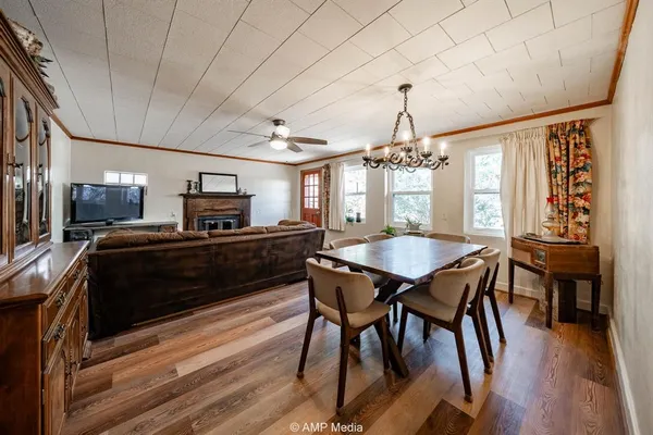 a kitchen with a dining table chairs stainless steel appliances and cabinets
