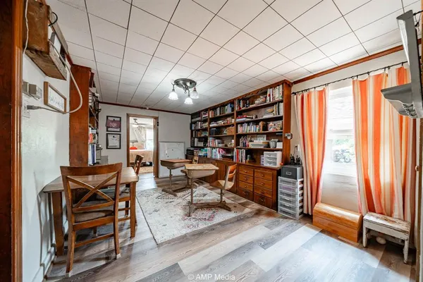 a very nice looking room with many windows and furniture