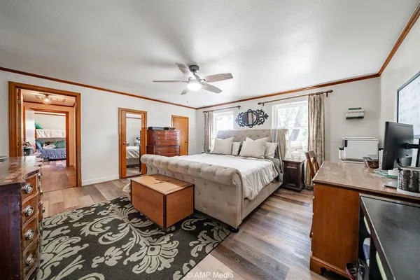 a spacious bedroom with a bed a couch and dresser