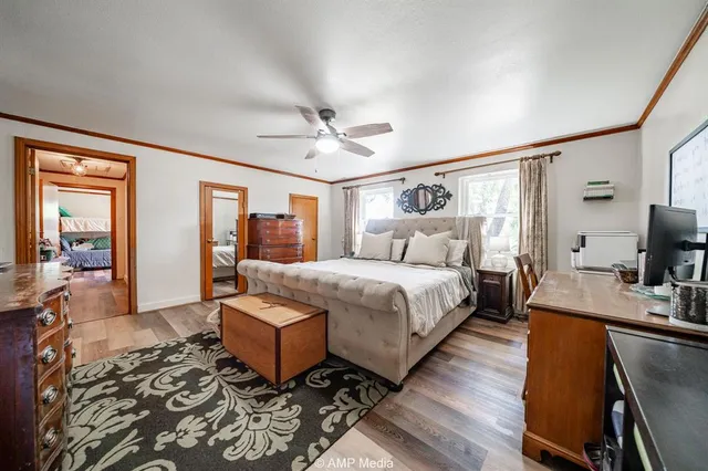 a spacious bedroom with a bed a couch and dresser