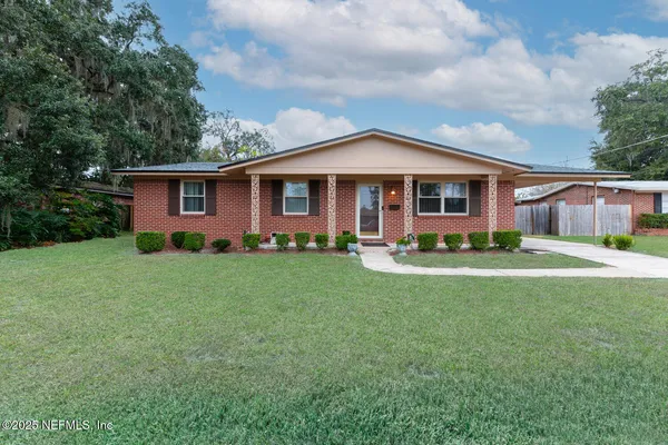 a front view of a house with a yard and porch