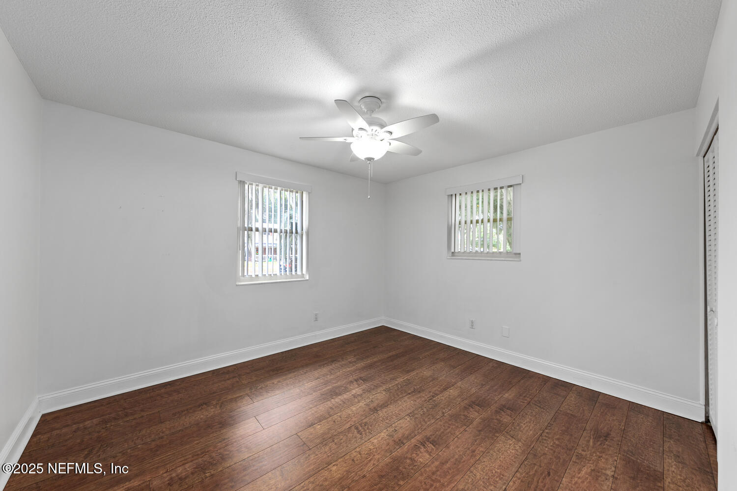 1144 Crown Drive Jacksonville, FL 32221 - Photo 12 of 20 an empty room with wooden floor and windows