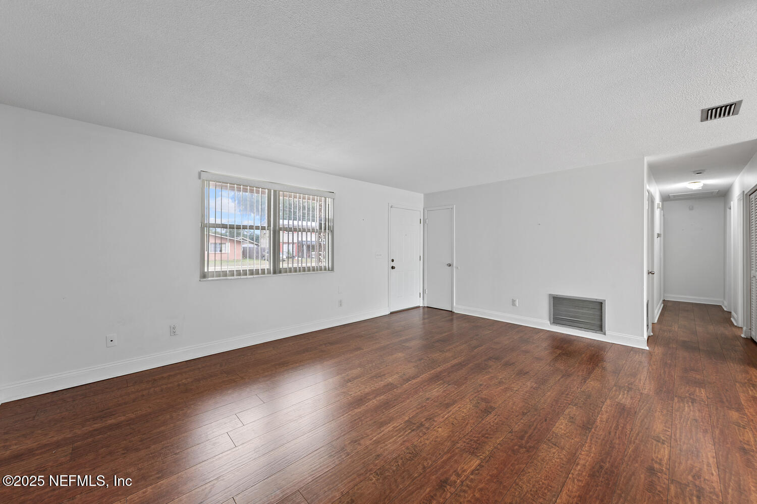 1144 Crown Drive Jacksonville, FL 32221 - Photo 5 of 20 an empty room with wooden floor and windows