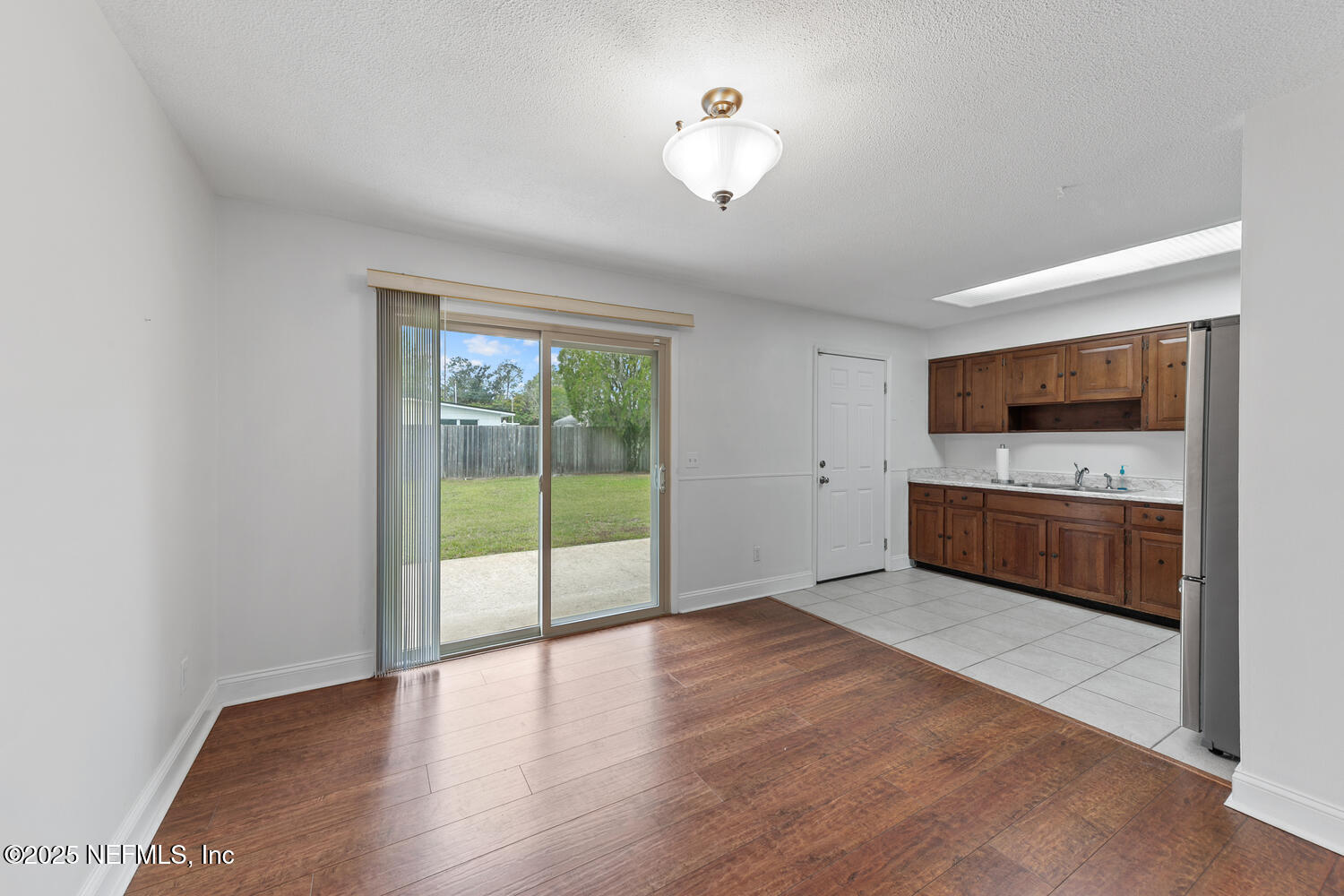 1144 Crown Drive Jacksonville, FL 32221 - Photo 6 of 20 a view of an empty room with a window and wooden floor
