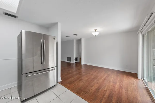 a kitchen with granite countertop stainless steel appliances and white cabinets