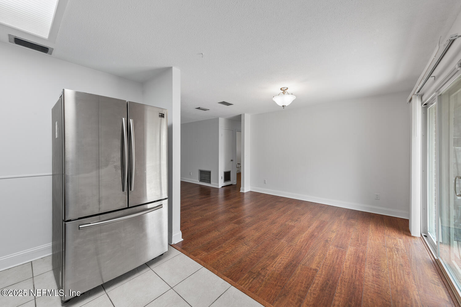 1144 Crown Drive Jacksonville, FL 32221 - Photo 8 of 20 a view of a kitchen with a refrigerator and wooden floor