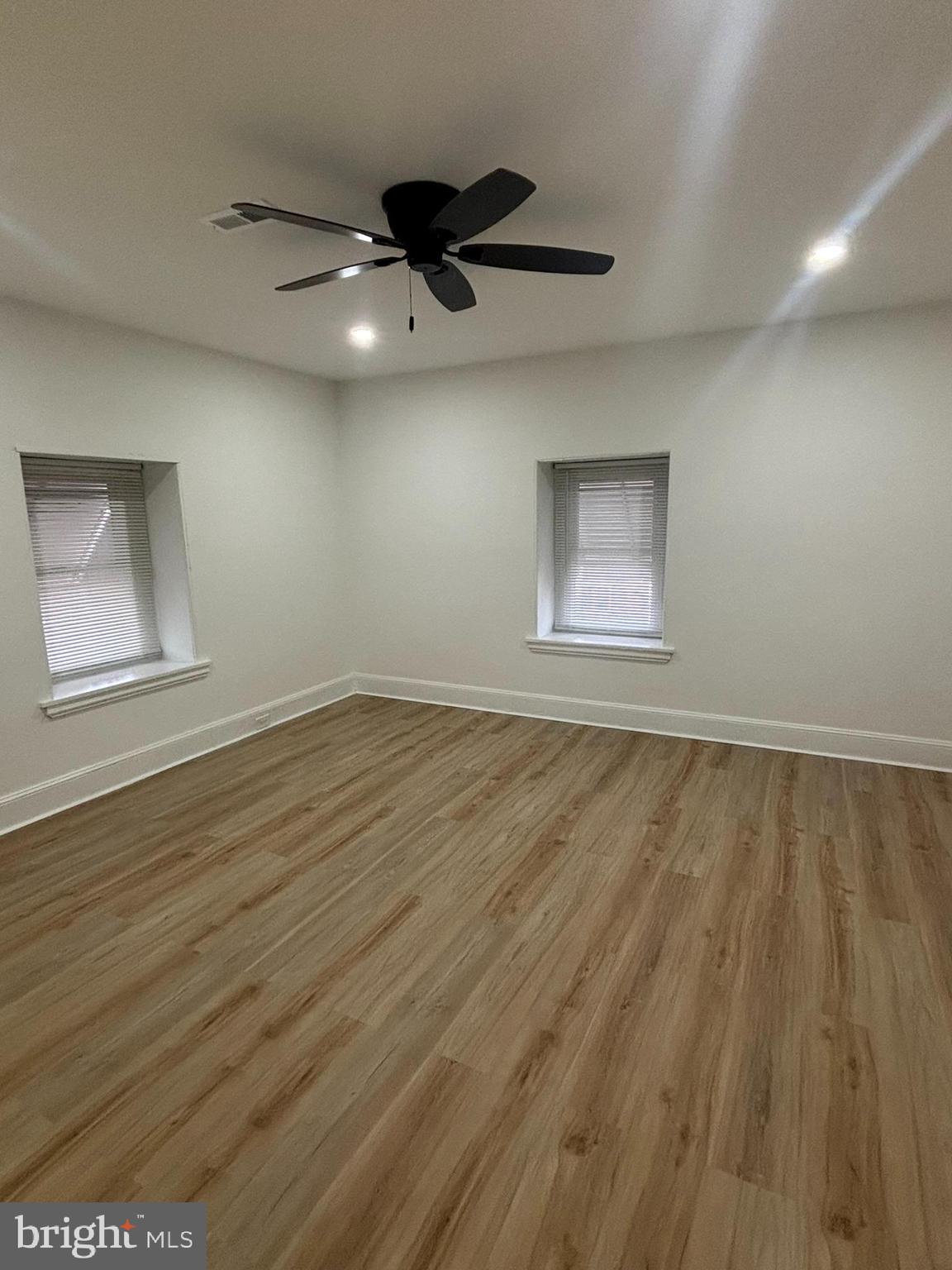 320 Loney Street, Unit (2ND FL) Philadelphia, PA 19111 - Photo 12 of 19 a view of an empty room with wooden floor and a ceiling fan
