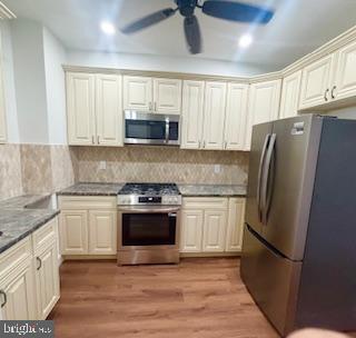 320 Loney Street, Unit (2ND FL) Philadelphia, PA 19111 - Photo 3 of 19 a kitchen with stainless steel appliances a refrigerator sink and microwave