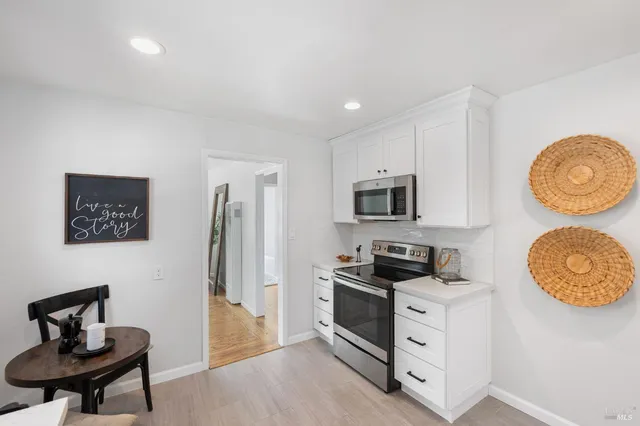 a kitchen with stainless steel appliances granite countertop a stove a refrigerator and a stove