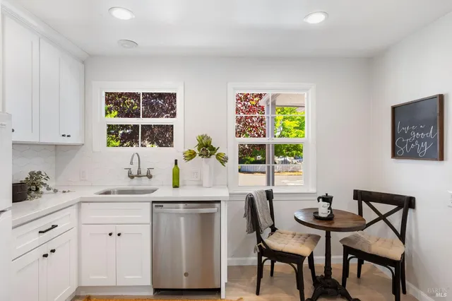 a kitchen with a sink cabinets and window