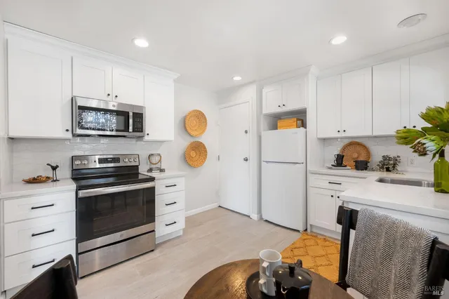 a kitchen with a sink appliances and cabinets