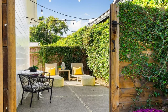 a view of patio with table and chairs and potted plants
