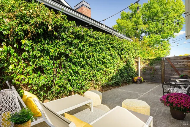 a backyard of a house with outdoor seating