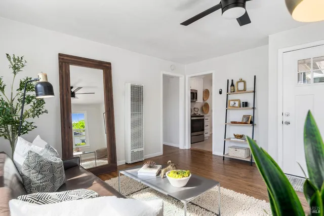a living room with furniture and wooden floor