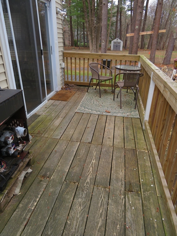 34 R Pine Street Norton, MA 02766 - Photo 2 of 20 a balcony with wooden floor table and chairs
