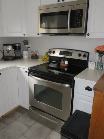 a kitchen with stainless steel appliances granite countertop a stove and a microwave