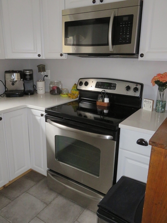 34 R Pine Street Norton, MA 02766 - Photo 9 of 20 a kitchen with stainless steel appliances granite countertop a stove and a microwave