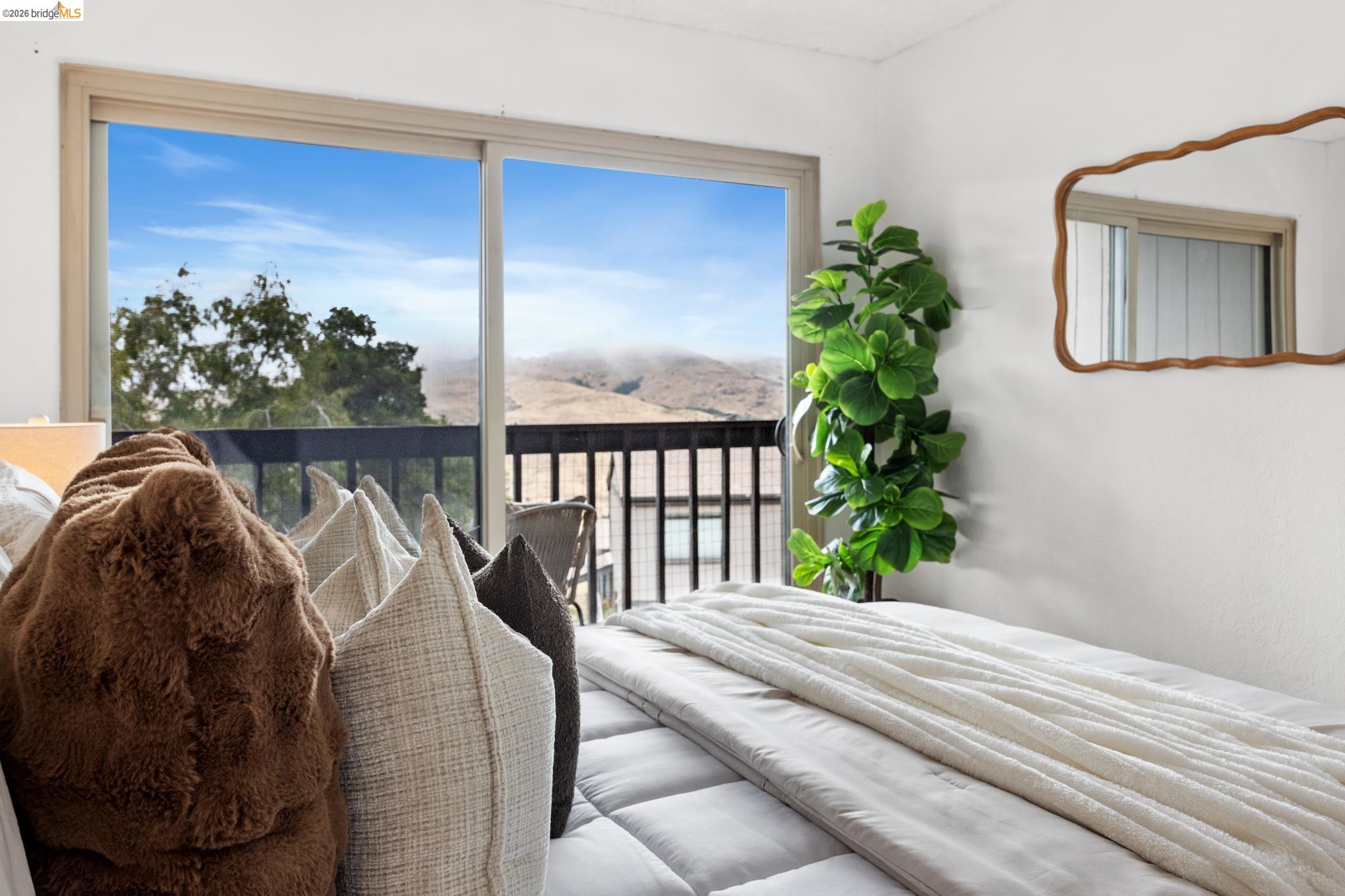 201 Vista Heights Road El Cerrito, CA 94530 - Photo 16 of 32 Sliding glass door opening to a private balcony with natural landscape beyond