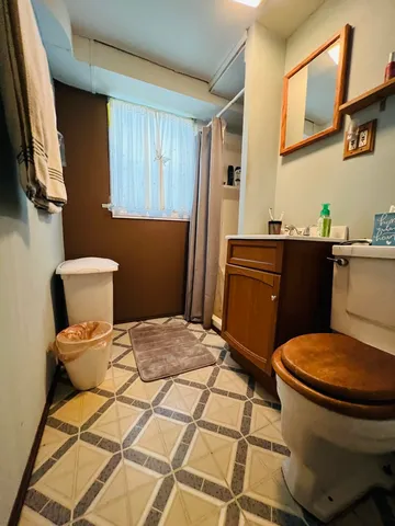 a bathroom with a sink toilet and a mirror