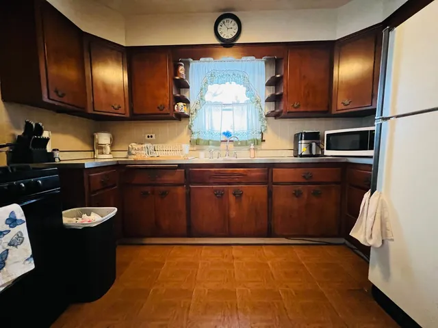 a kitchen with a sink cabinets and stainless steel appliances