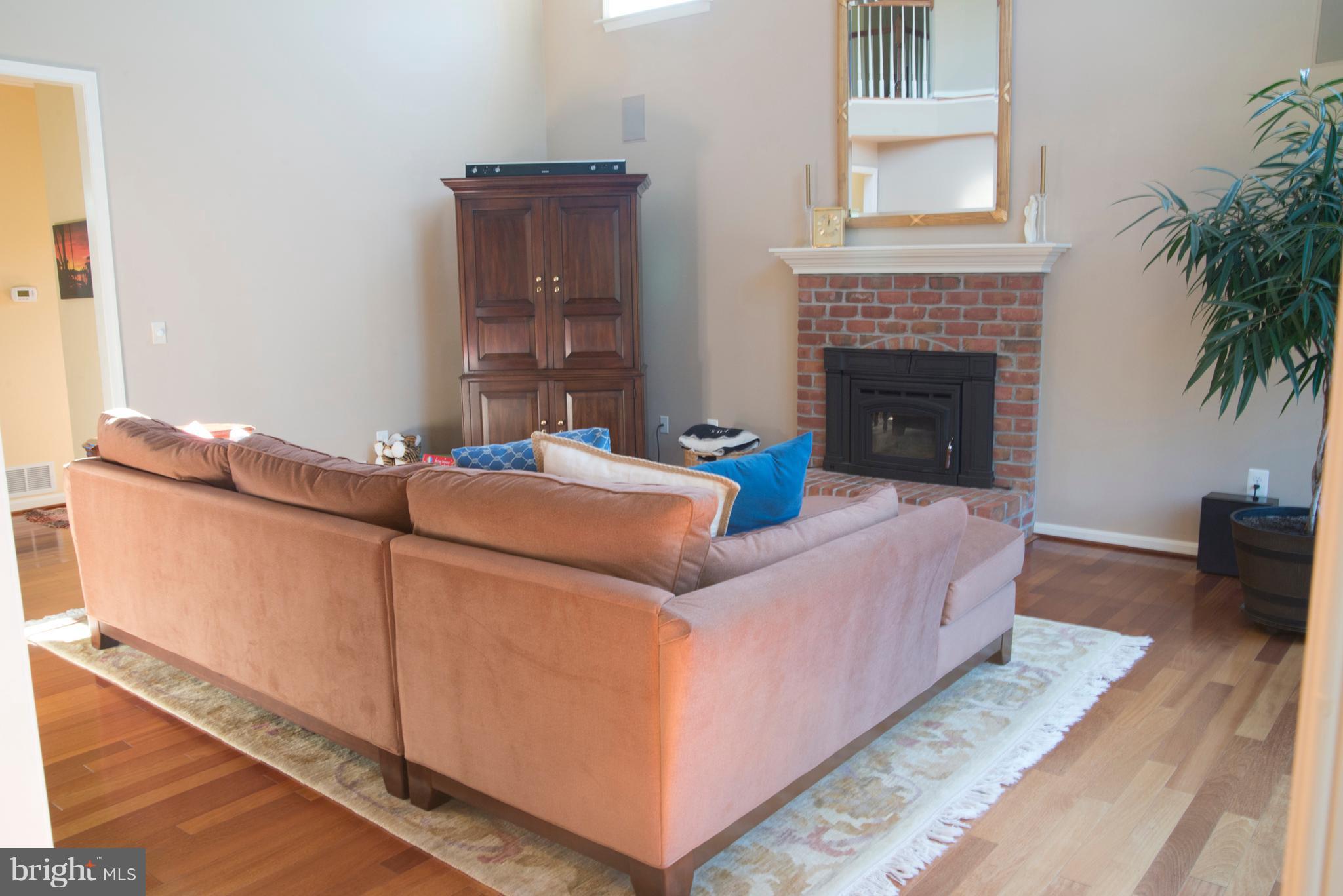Family Room w/wood stove insert + hardwood floors