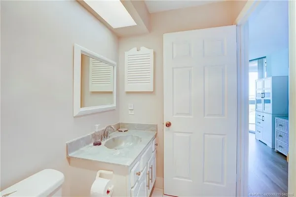 a bedroom with a bed and a flat tv screen on dresser