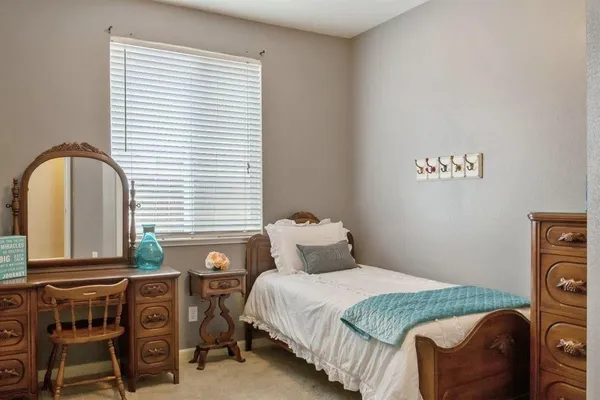 a bed sitting in a bedroom next to a window