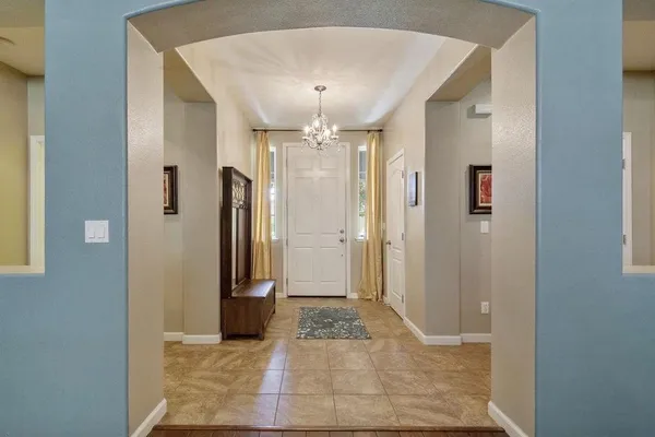 a view of a hallway with wooden floor and a cabinet