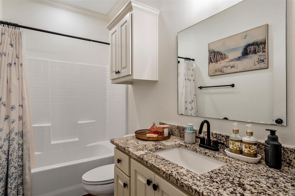 1672 Alamo Xing Road Tyler, TX 75701 - Photo 13 of 25 a bathroom with a granite countertop sink a toilet and shower