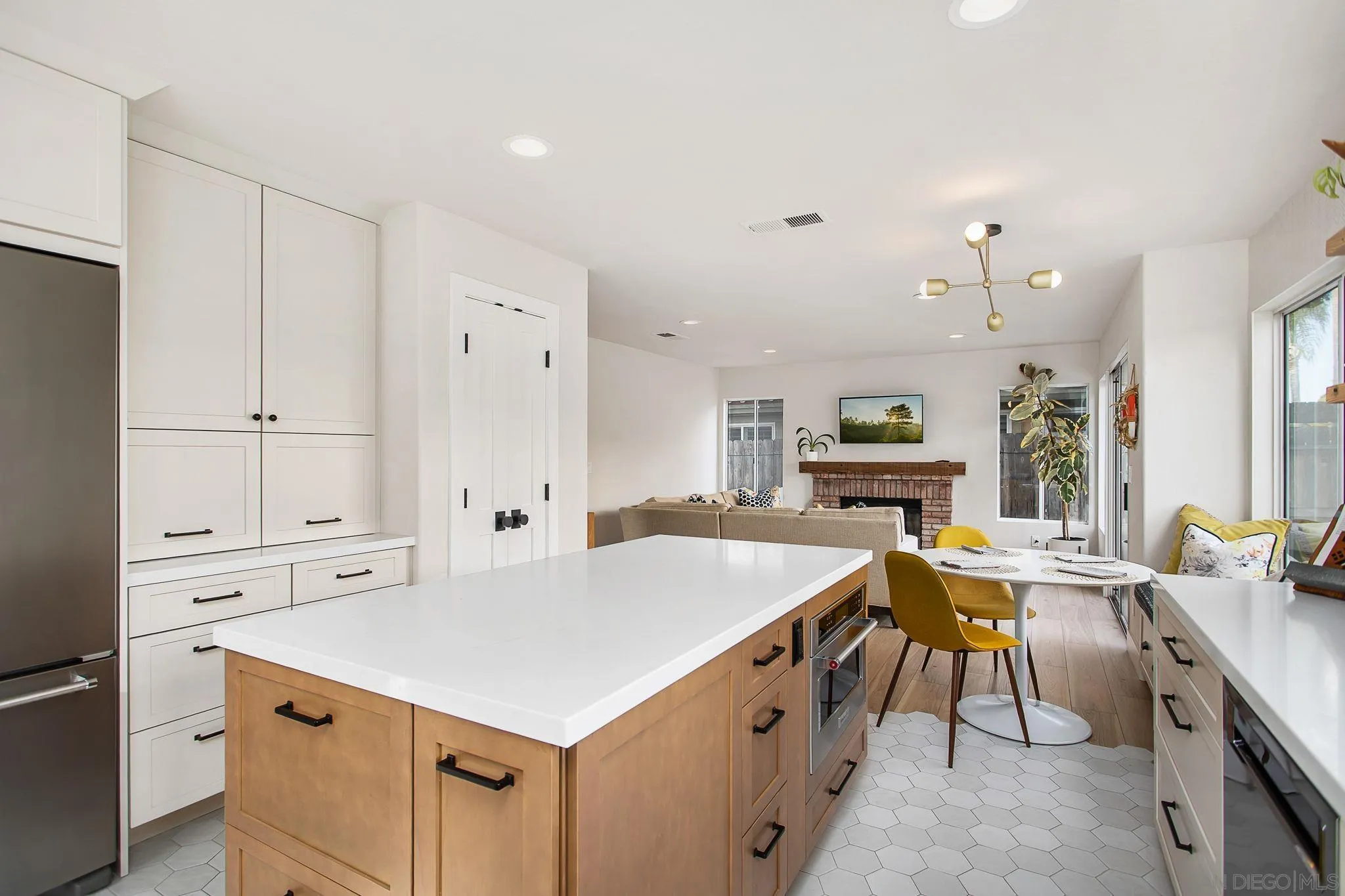 649 Mosaic Circle Oceanside, CA 92057 - Photo 11 of 52 a kitchen that has a lot of cabinets in it and wooden floors