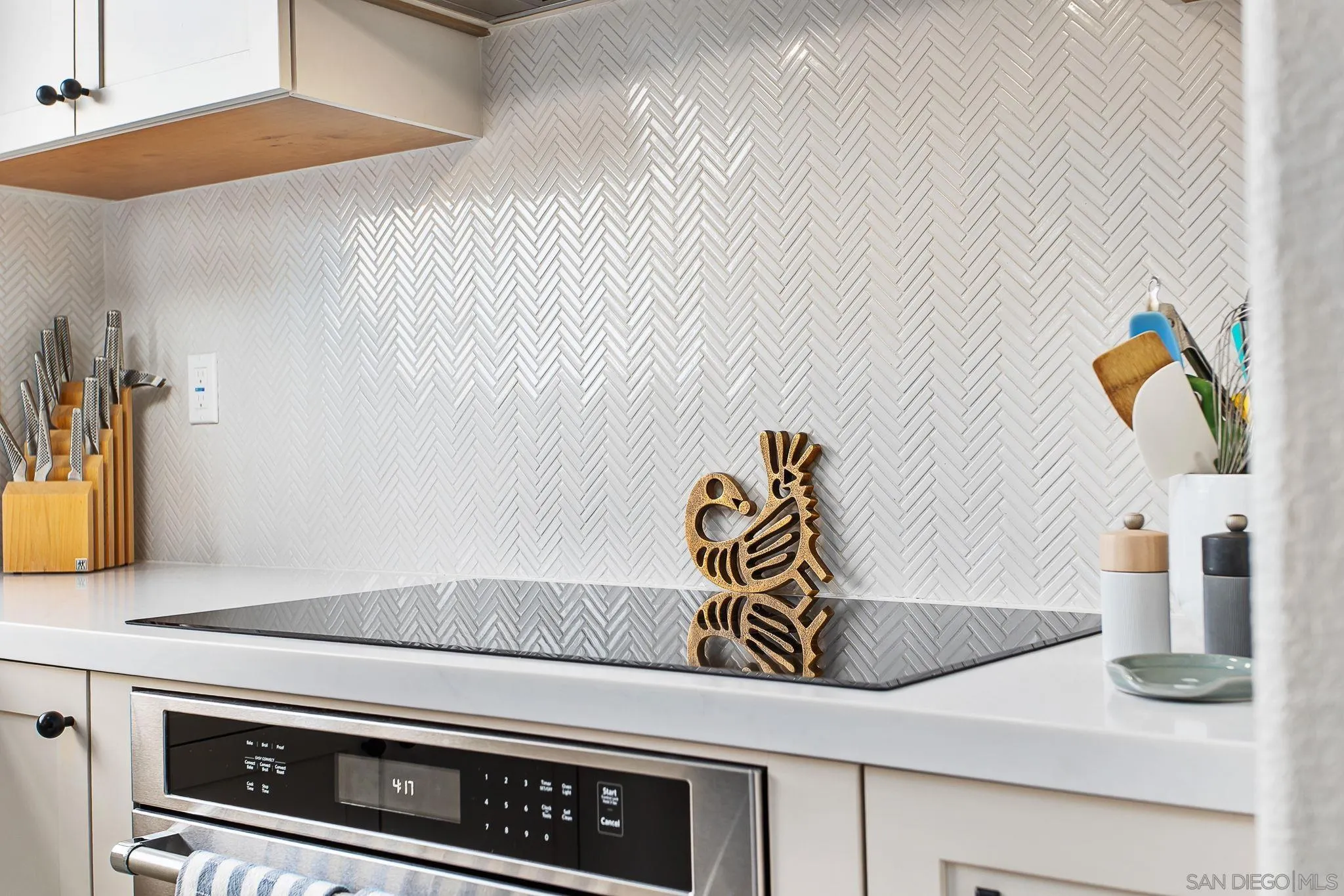 649 Mosaic Circle Oceanside, CA 92057 - Photo 13 of 52 a close view of kitchen countertops with stove and white cabinets
