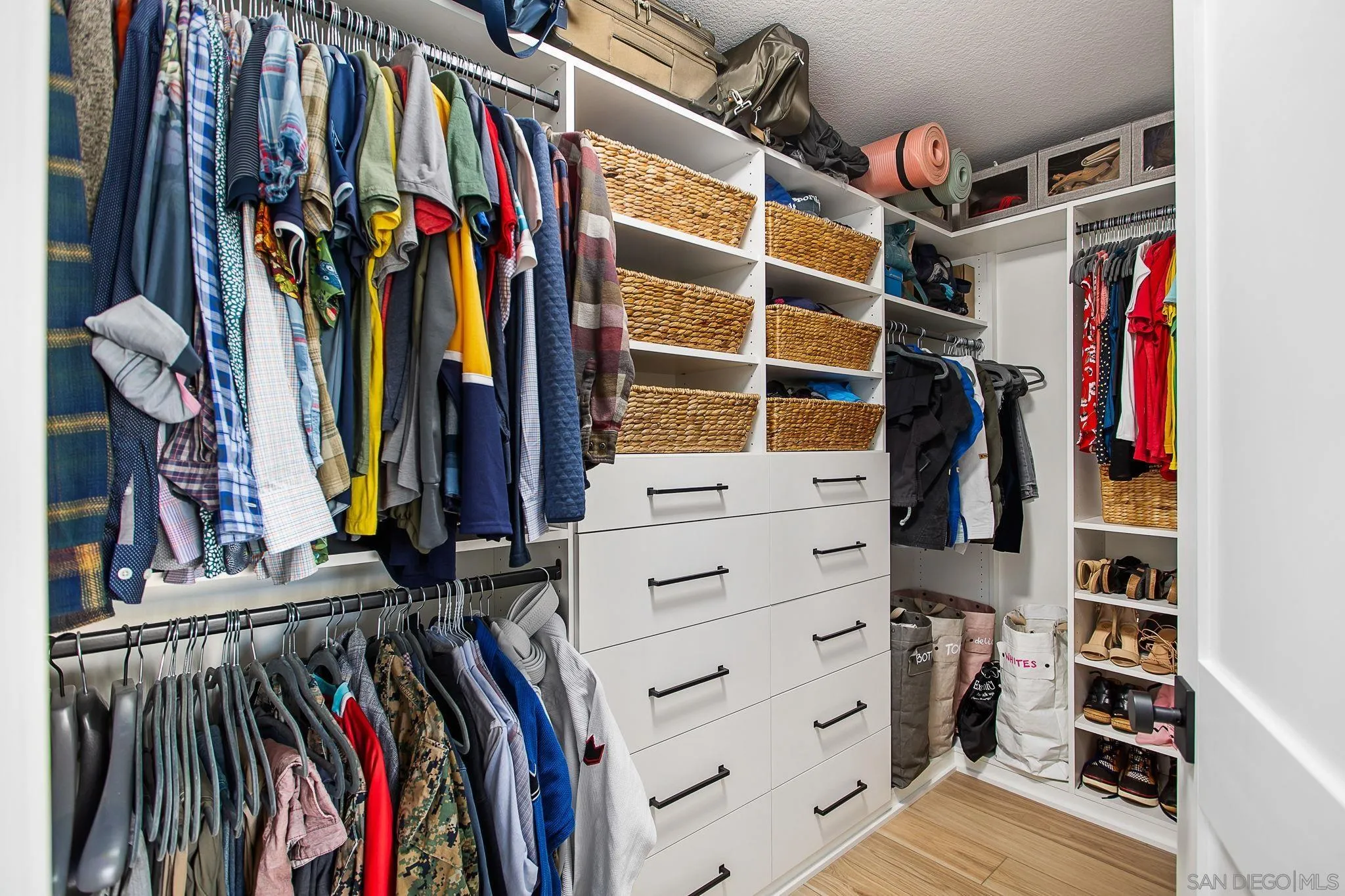 649 Mosaic Circle Oceanside, CA 92057 - Photo 26 of 52 a view of walk in closet with clothes and shoes