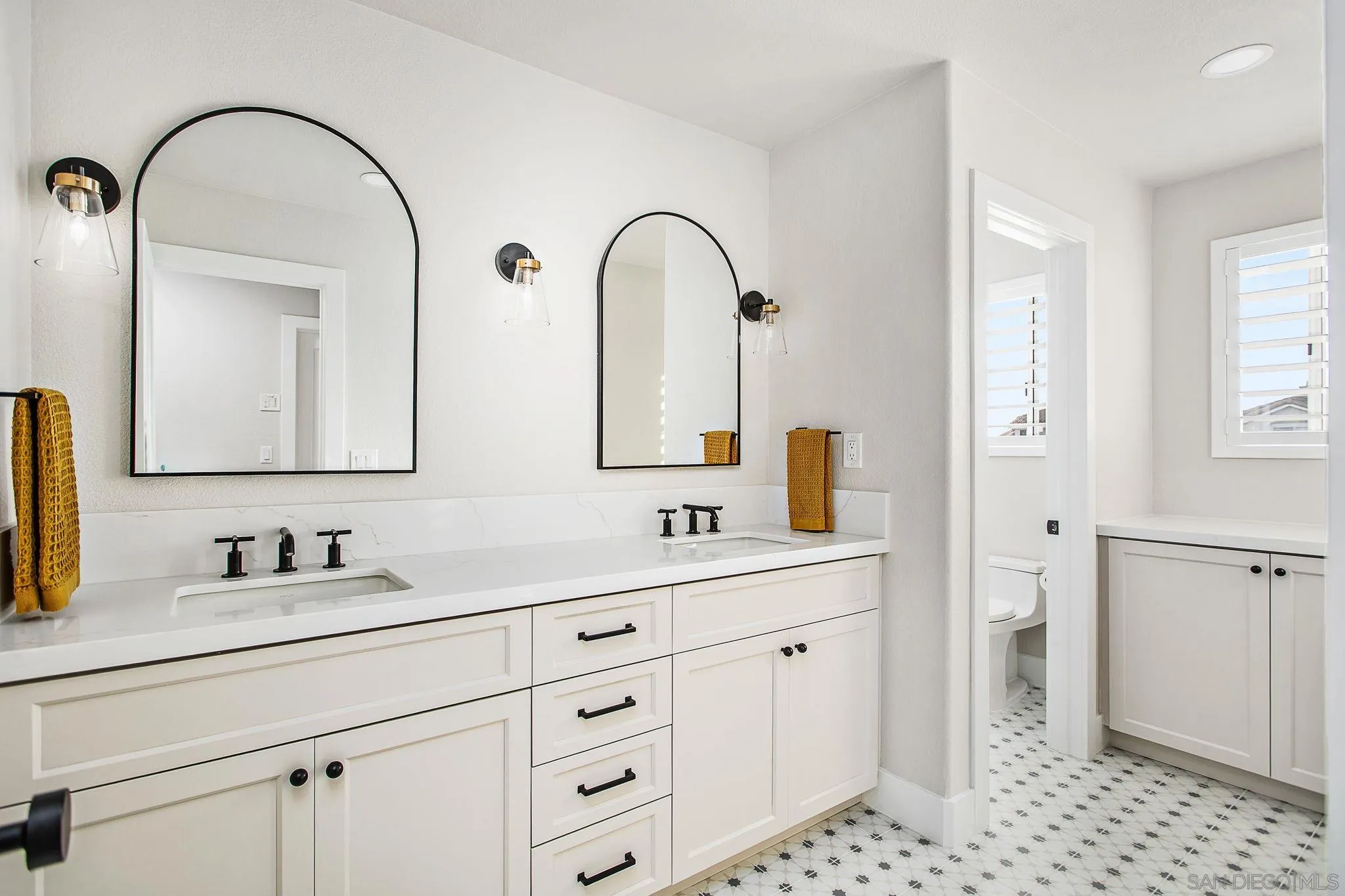 649 Mosaic Circle Oceanside, CA 92057 - Photo 30 of 52 a bathroom with a double vanity sink and mirror