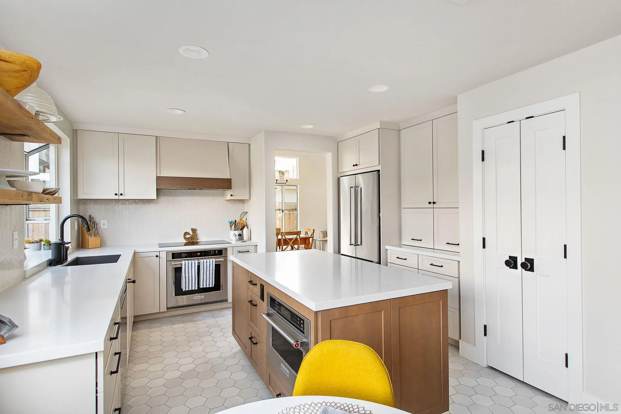 649 Mosaic Circle Oceanside, CA 92057 - Photo 9 of 52 a kitchen with kitchen island granite countertop a sink a stove and refrigerator