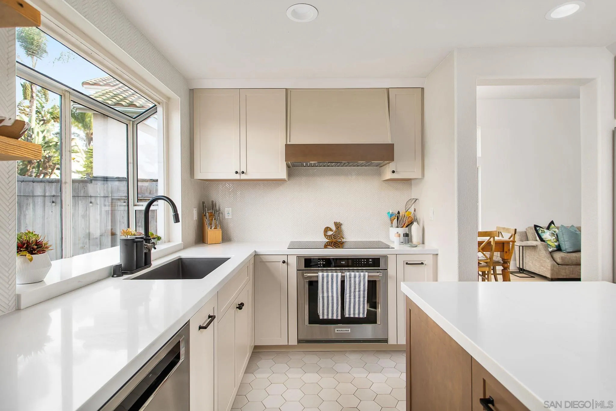649 Mosaic Circle Oceanside, CA 92057 - Photo 10 of 52 a kitchen with stainless steel appliances granite countertop a sink stove and white cabinets