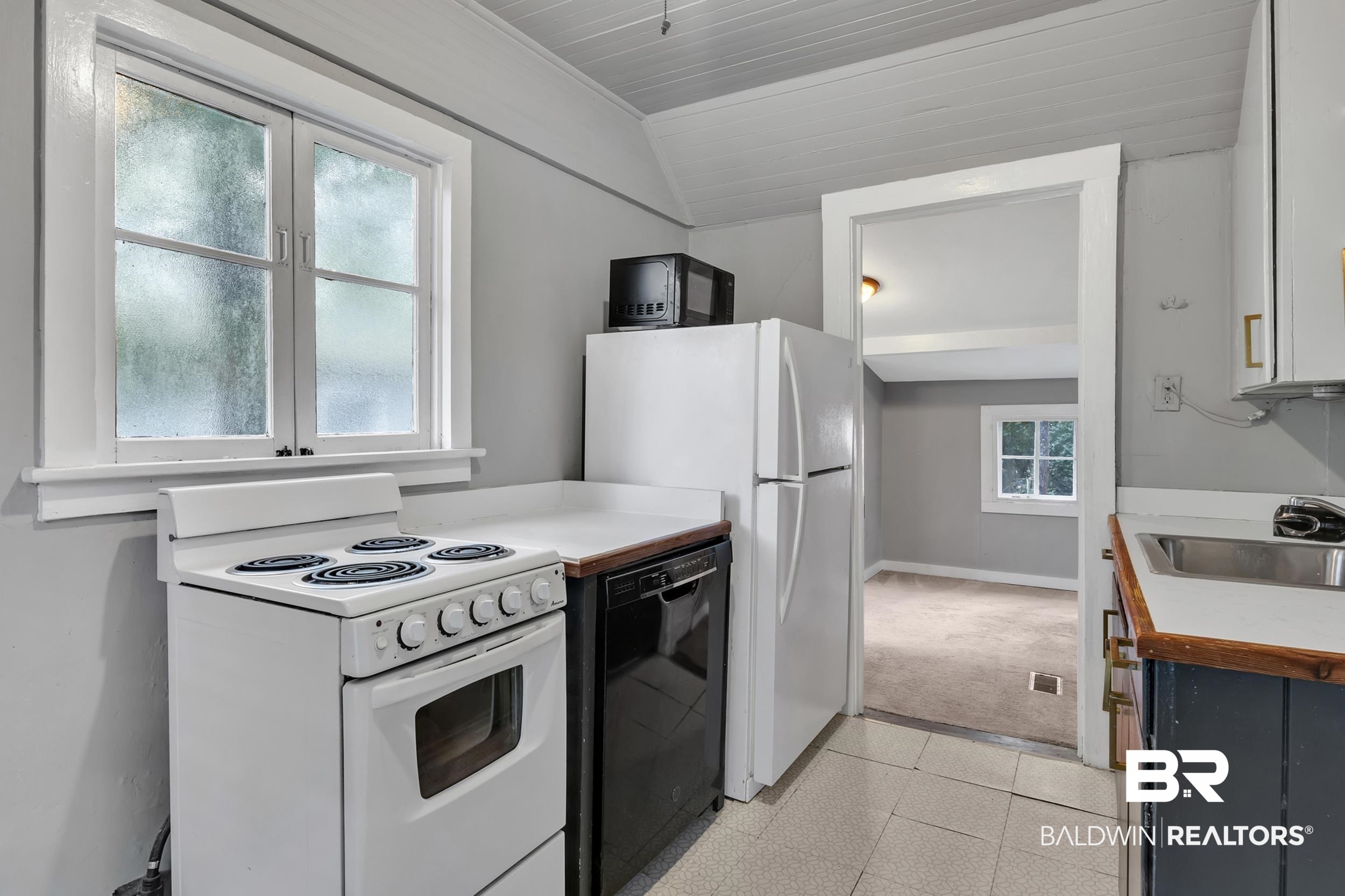 55 Boise Lane Fairhope, AL 36532 - Photo 20 of 24 Kitchen featuring black and white appliances and light countertops